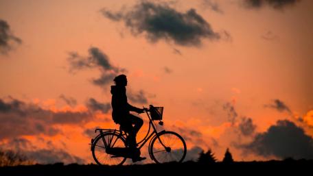 Silhouette of a Cyclist Against a Stunning Sunset Sky wallpaper