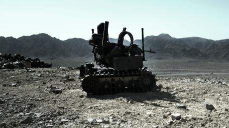 Armored Robot on Rugged Terrain wallpaper