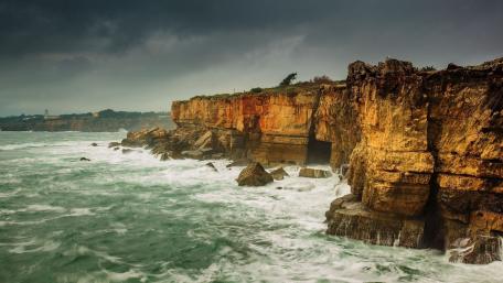 Rugged Coastline Under Stormy Skies wallpaper