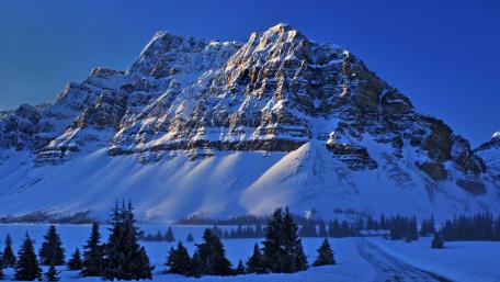Majestic Winter Peaks Awash in Blue Light wallpaper