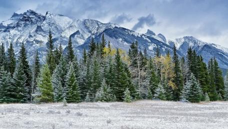 Snowy Mountain Landscape Under Cloudy Skies wallpaper