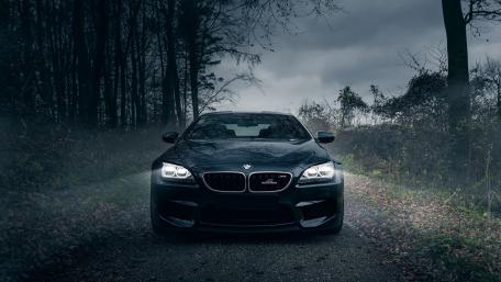Powerful BMW M5 in the Dark Woods wallpaper