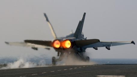 Jet Fighter Launching from Aircraft Carrier at Sea wallpaper