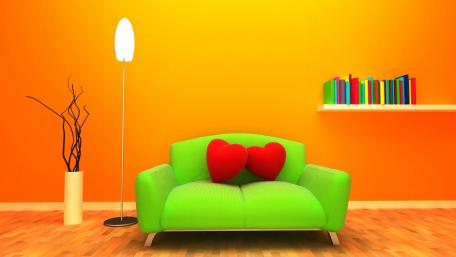 Orange room with a green couch with red heart pillows. wallpaper