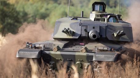 Powerful Tank in Action Amidst Dust Storm wallpaper