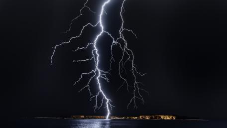 Electric Fury Over Tranquil Seas wallpaper