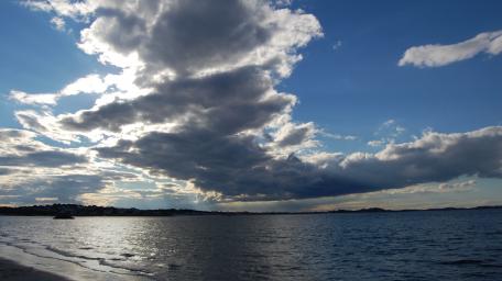 Dramatic Clouds Over a Serene Ocean Scene wallpaper