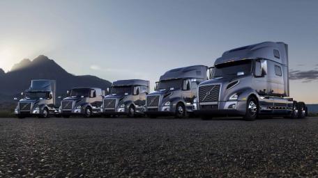 Powerful Volvo Trucks Displayed Together in Nature's Beauty wallpaper