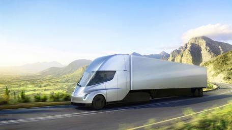 Futuristic Tesla Semi Driving Through Scenic Landscape wallpaper