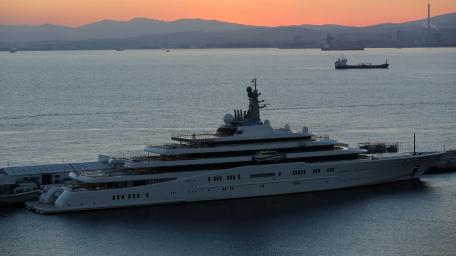 Luxury Yacht at Sunset Viewing Expansive Waters wallpaper