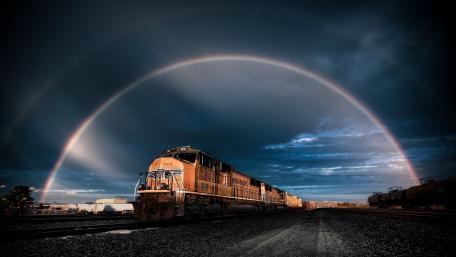 Railway Journey Under a Dazzling Rainbow wallpaper