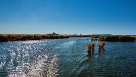 Tranquil Lake Under a Clear Blue Sky wallpaper
