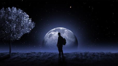 Man Standing Under a Giant Moonlit Sky wallpaper