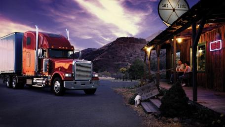 Red Semi Truck at Rustic Cafe Under Sunset Sky wallpaper