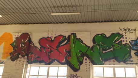 Vibrant Graffiti Art on Textured Wall Surface wallpaper
