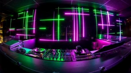 Neon DJ Console in Vibrant Nightclub Atmosphere wallpaper