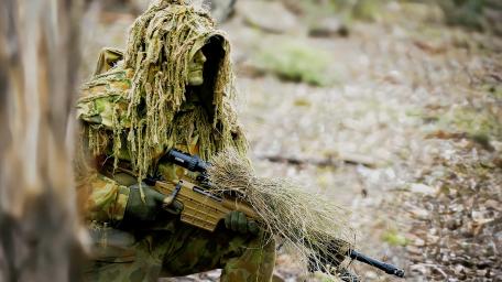 Camouflaged Warrior in Action wallpaper