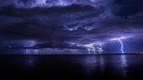 Electric Fury Over Tranquil Seas wallpaper
