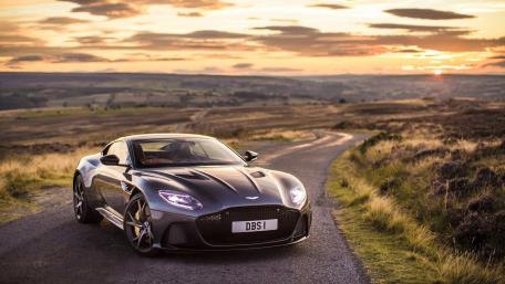 Aston Martin DBS Against a Stunning Sunset Landscape wallpaper