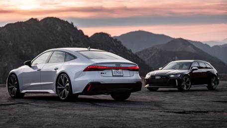 Sleek Audi Cars Against a Mountain Sunset wallpaper
