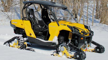 Yellow All-Terrain Vehicle in Snowy Landscape wallpaper