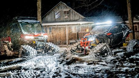 Powerful Snowmobiles in a Winter Wonderland Scene wallpaper