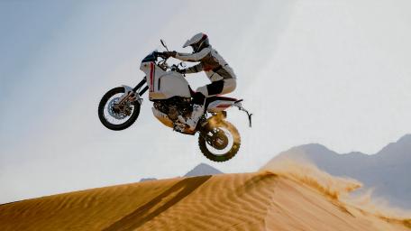 Epic Motorcycle Jump in the Desert Sand wallpaper