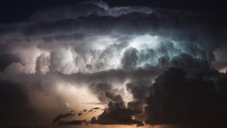 Dynamic Night Sky Illuminated by Lightning Storms wallpaper