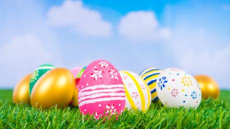 Colorful Easter Eggs in Vibrant Grass Scene wallpaper