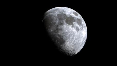 Luminous First Quarter Moon against Black Background wallpaper