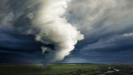 Tornado in a Vast Green Landscape wallpaper