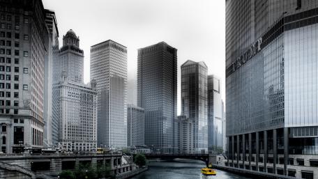 Boat Going Through River in Between High-rise Buildings wallpaper