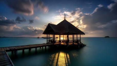 Serene Sunset Over Tranquil Pier wallpaper