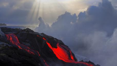 Fiery Eruption at the Ocean's Edge wallpaper