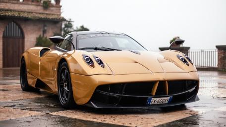 Golden Pagani Huayra in a Dreamy Setting wallpaper