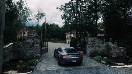 Luxury Entrance with a Sleek Automobile in Focus wallpaper