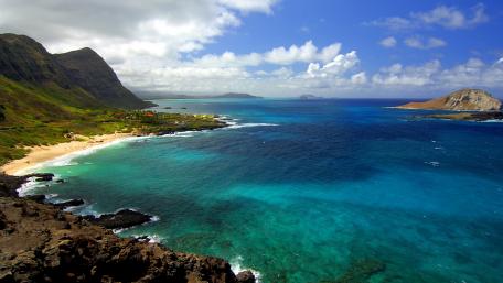 Serene Coastal View Under Clear Blue Skies wallpaper