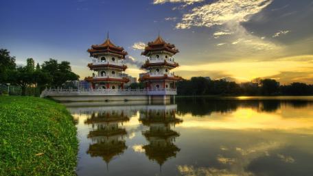 Serene Pagoda at Sunset Over Tranquil Lake wallpaper