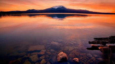 Orange Sunset Reflections over Serene Lake Waters wallpaper