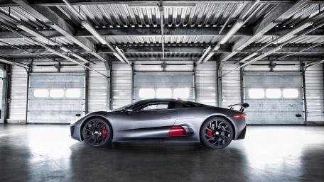 Sleek Jaguar C-X75 in Industrial Setting wallpaper