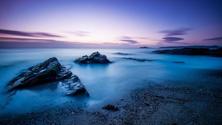 Serene Dusk Over Calm Sea Shoreline wallpaper