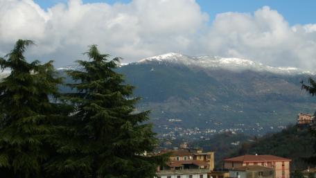 Stunning Cityscape with Majestic Snow-Capped Mountains wallpaper