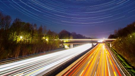 Star Trails Over an Empty Highway at Night wallpaper