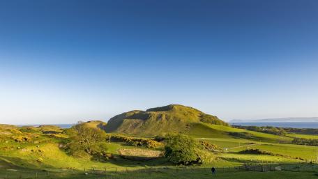 Serene Green Hills Under a Clear Sky wallpaper