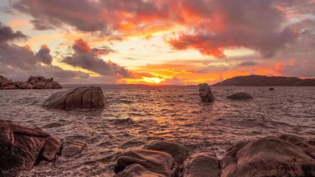 Breathtaking Sunset Over Tranquil Sea Shore wallpaper