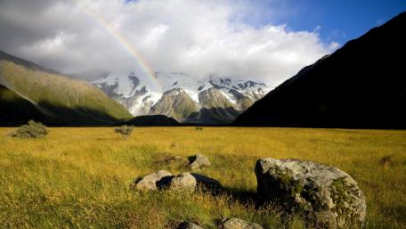 Majestic Rainbow Over Serene Mountainscape wallpaper