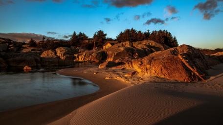 Serene Sunset Over Sandy Beach and Calm Sea wallpaper