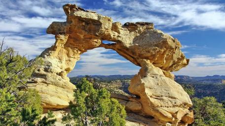 Majestic Natural Arch in Scenic Landscape wallpaper