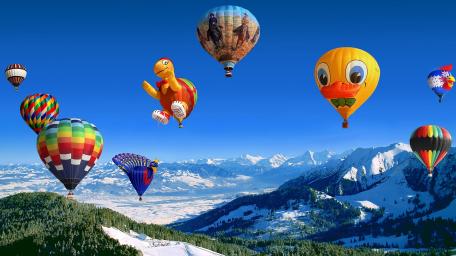 Hot Air Balloons Over Snowy Mountains wallpaper