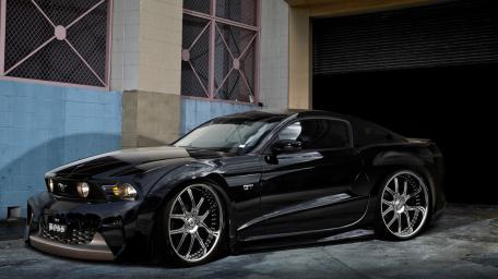 Sleek Black Car in Modern Garage Setting wallpaper